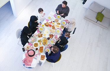 Image showing traditional muslim family praying before iftar dinner