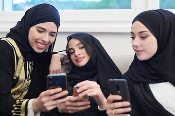 Image showing muslim women using mobile phone at home