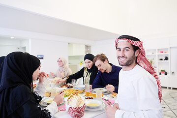 Image showing young arabian man having Iftar dinner with muslim family