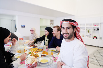 Image showing young arabian man having Iftar dinner with muslim family