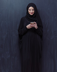 Image showing young modern muslim business woman using smartphone