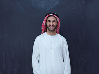 Image showing portrait of arabian man in front of black chalkboard