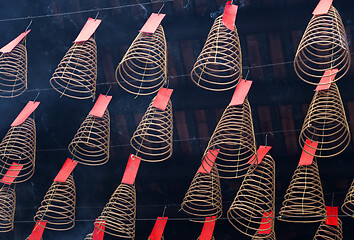 Image showing Spiral incense burning hanging in Vietnamese temple