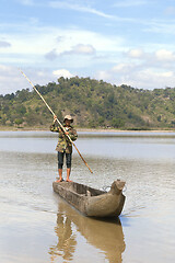 Image showing Dak Lak, VIETNAM - JANUARY 6, 2015 - Man pushing a boat with a pole