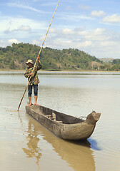 Image showing Dak Lak, VIETNAM - JANUARY 6, 2015 - Man pushing a boat with a pole