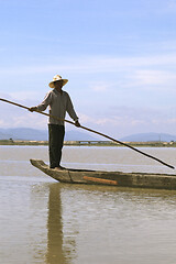 Image showing Dak Lak, VIETNAM - JANUARY 6, 2015 - Man pushing a boat with a pole