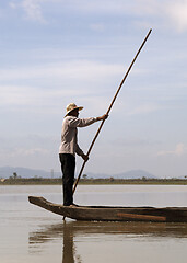 Image showing Dak Lak, VIETNAM - JANUARY 6, 2015 - Man pushing a boat with a pole