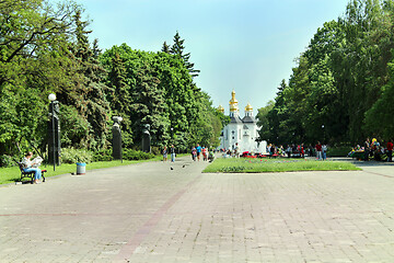 Image showing People have a rest in park with big trees and fountains