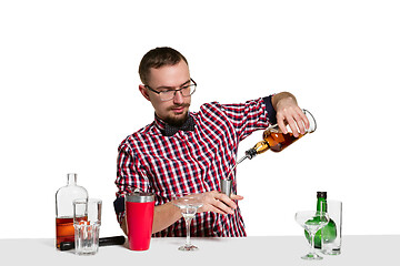 Image showing Expert barman is making cocktail at studio