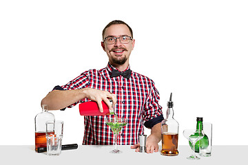 Image showing Expert barman is making cocktail at studio