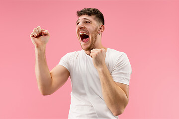 Image showing Winning success man happy ecstatic celebrating being a winner. Dynamic energetic image of male model