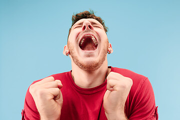 Image showing Winning success man happy ecstatic celebrating being a winner. Dynamic energetic image of male model