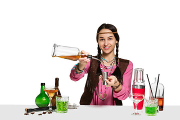 Image showing Expert female barman is making cocktail at studio