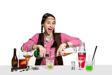 Image showing Expert female barman is making cocktail at studio