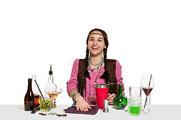 Image showing Expert female barman is making cocktail at studio