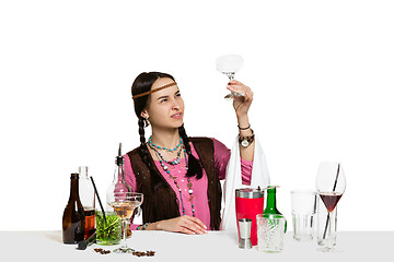 Image showing Expert female barman is making cocktail at studio