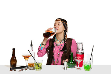 Image showing Expert female barman is making cocktail at studio