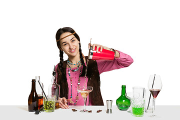 Image showing Expert female barman is making cocktail at studio