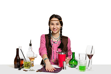 Image showing Expert female barman is making cocktail at studio