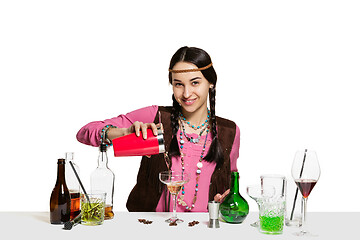 Image showing Expert female barman is making cocktail at studio