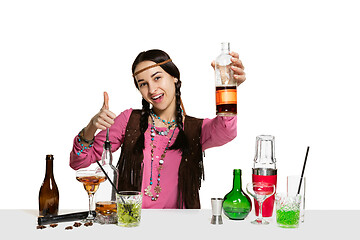 Image showing Expert female barman is making cocktail at studio