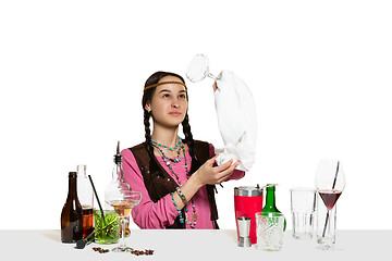 Image showing Expert female barman is making cocktail at studio