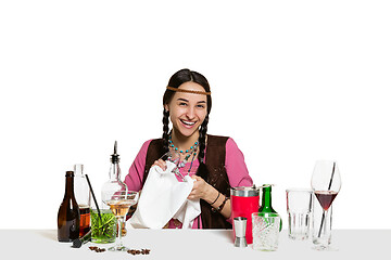 Image showing Expert female barman is making cocktail at studio