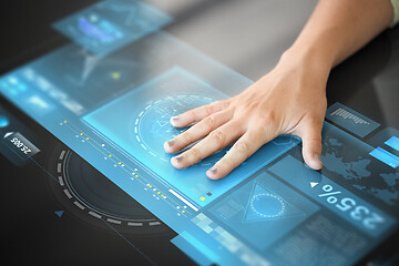 Image showing hand using black interactive panel with charts