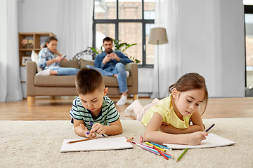 Image showing brother and sister drawing with crayons at home