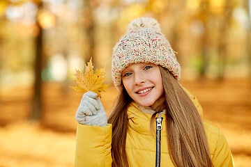 Image showing portrait of girl with maple leaf at autumn park