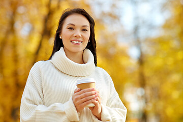 Image showing woman drinking takeaway coffee in autumn park