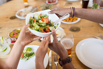 Image showing international friends eating at restaurant