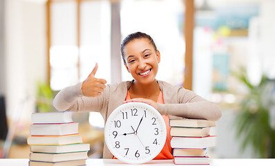 Image showing african american student with clock and books