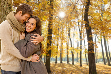 Image showing smiling couple hugging in autumn park