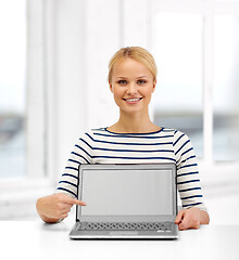 Image showing smiling woman with laptop computer at office