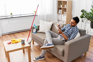 Image showing indian man with to do list after home cleaning