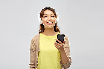 Image showing asian woman in headphones listening to music