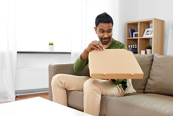 Image showing indian man looking inside of takeaway pizza box