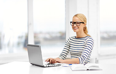 Image showing student woman in glasses with laptop and book