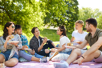 Image showing happy friends eating sandwiches at summer picnic