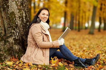 Image showing woman reading book at autumn park