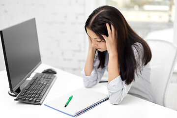 Image showing stressed businesswoman with computer at office