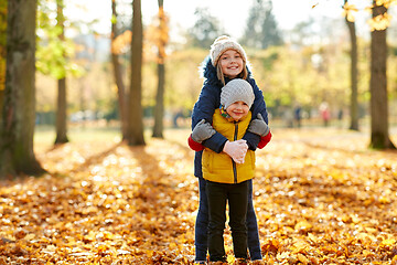 Image showing happy children hugging at autumn park