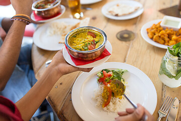 Image showing woman eating with friends at restaurant