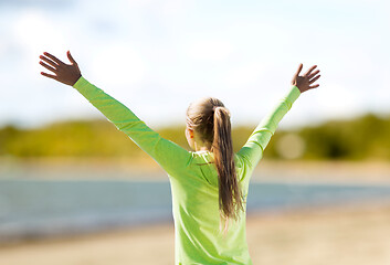 Image showing happy woman in sports clothes on beach