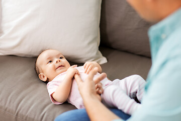 Image showing middle aged father playing with baby at home