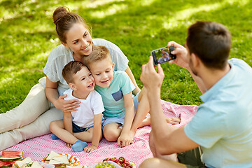 Image showing father taking picture of family on picnic at park