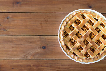 Image showing close up of apple pie in mold on wooden table