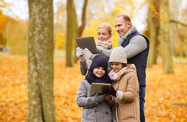 Image showing happy family with tablet pc in autumn park