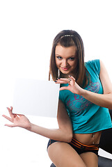 Image showing Pretty girl holds blank sheet